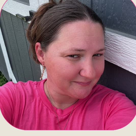 Kim Lawson smiling in a pink shirt